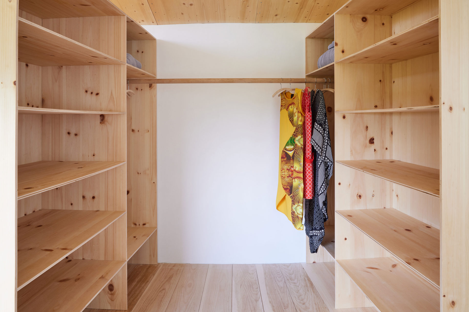 26 Casa Cometa Space Rental Interior Primary Bedroom walk in closet with built in pine plywood shelves