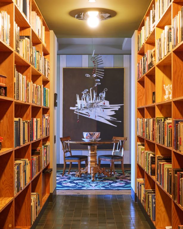 cocoon casa victoria library corridor bookshelves vertical
